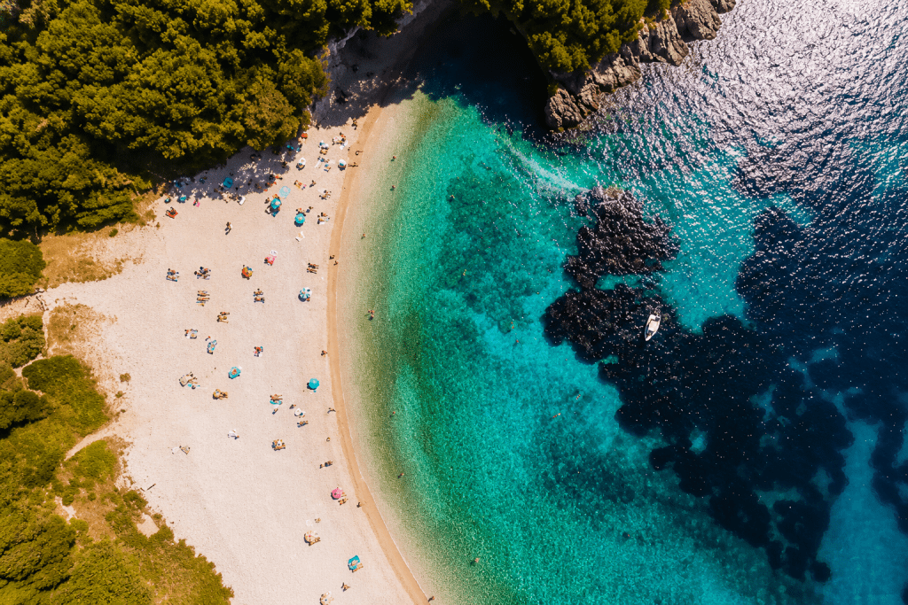 Panoramic view of Issos Beach in South Corfu featuring golden sand dunes, crystal-clear turquoise waters and the protected Natura 2000 wetland of Lake Korission near Chalikounas. Perfect destination for nature lovers, kitesurfing and peaceful beach holidays in Corfu.